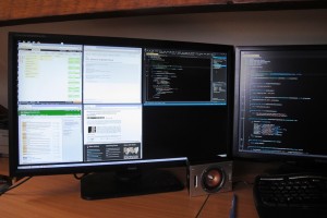 A photograph of the 4K screen with four browser windows and Visual Studio open.
